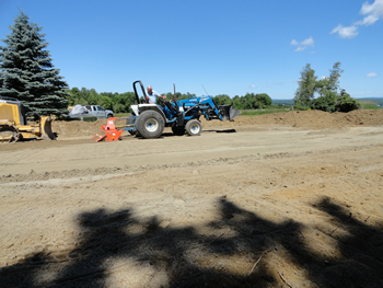 nitial rototilling in preparation of installing a new septic system by Rossignol's Excavating.